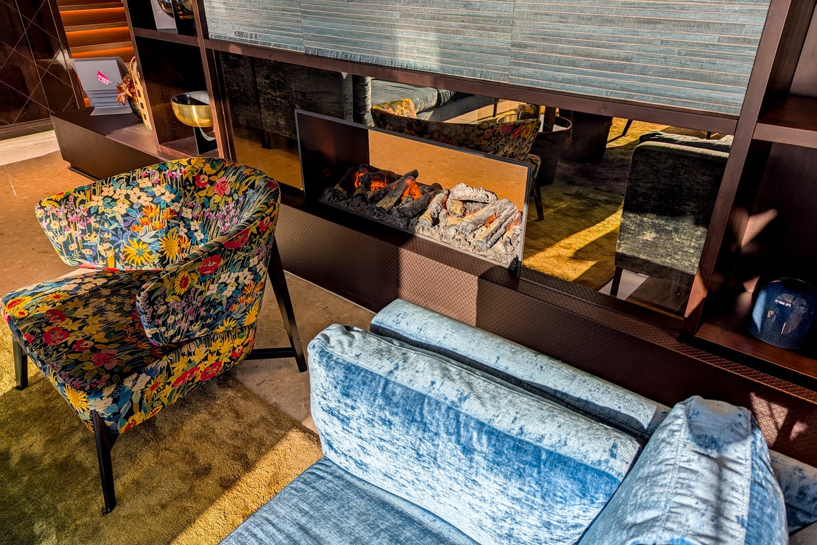 Cozy armchairs next to a faux fireplace on a river boat