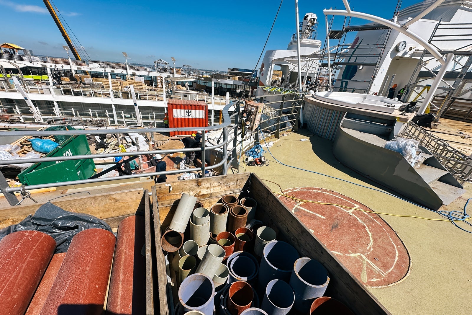 A construction zone on an open cruise ship deck with a hot tub nearby