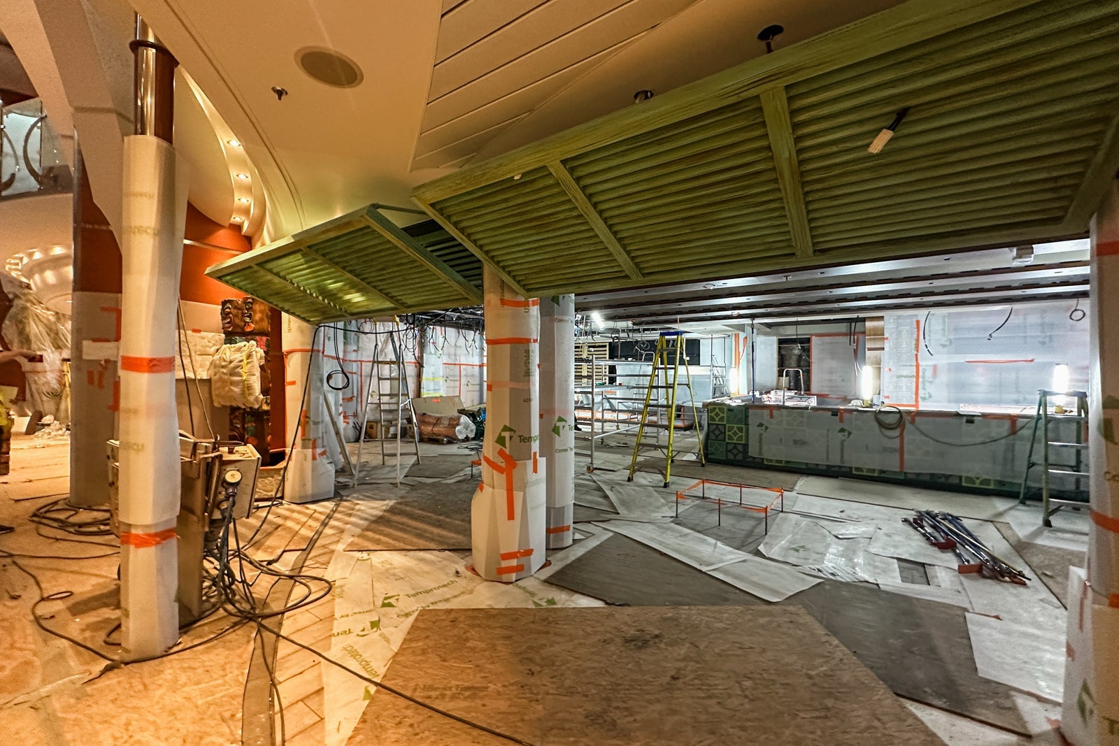 A cruise ship tiki bar under construction with two totem poles on one side