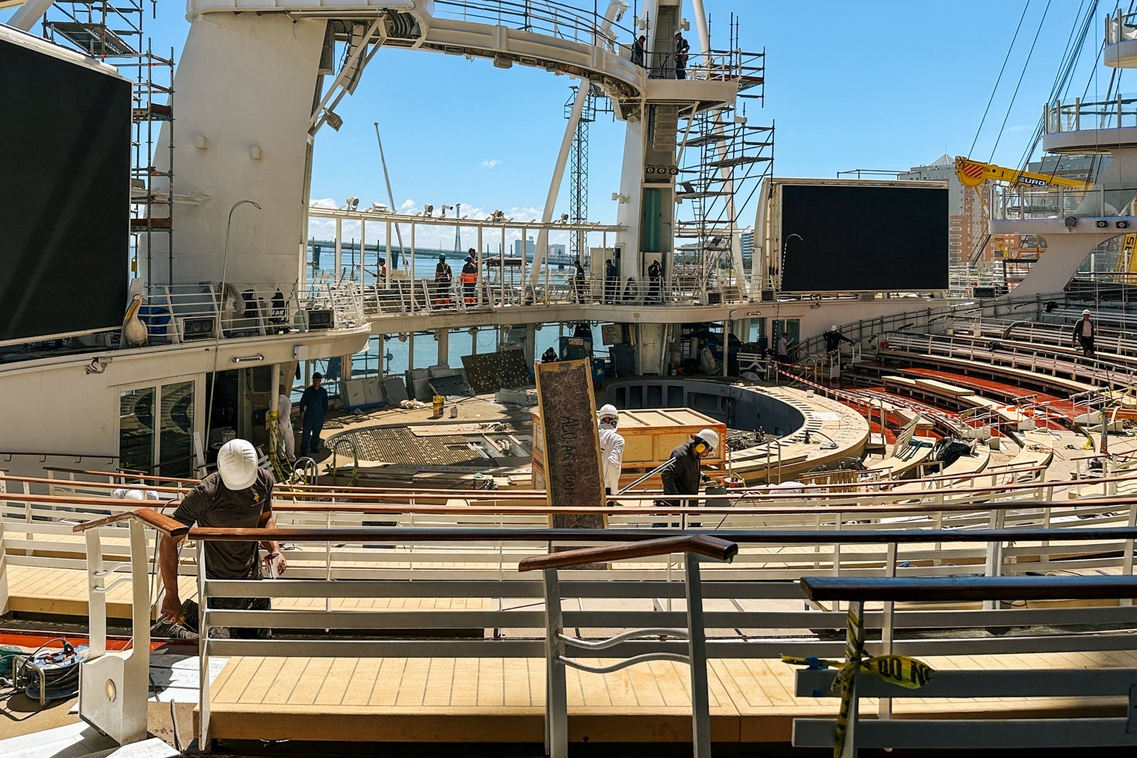 An outdoor theater on a cruise ship with stadium seating and high-dive platforms