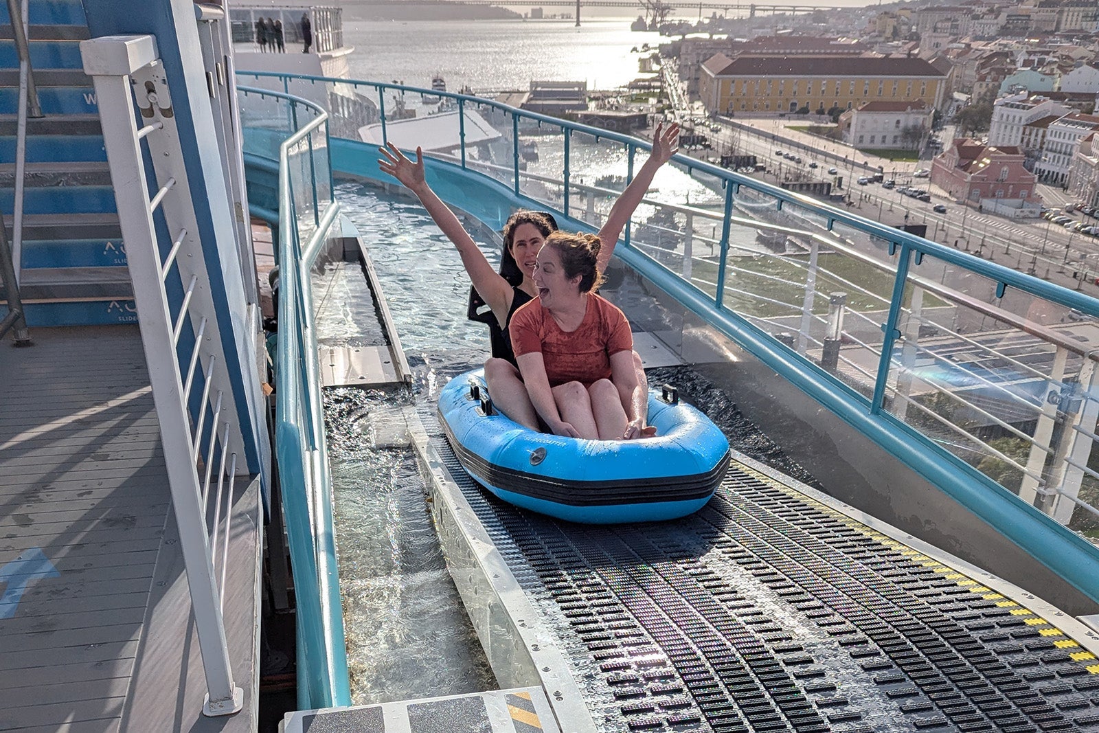 Two women laughing after cruise ship waterslide ride