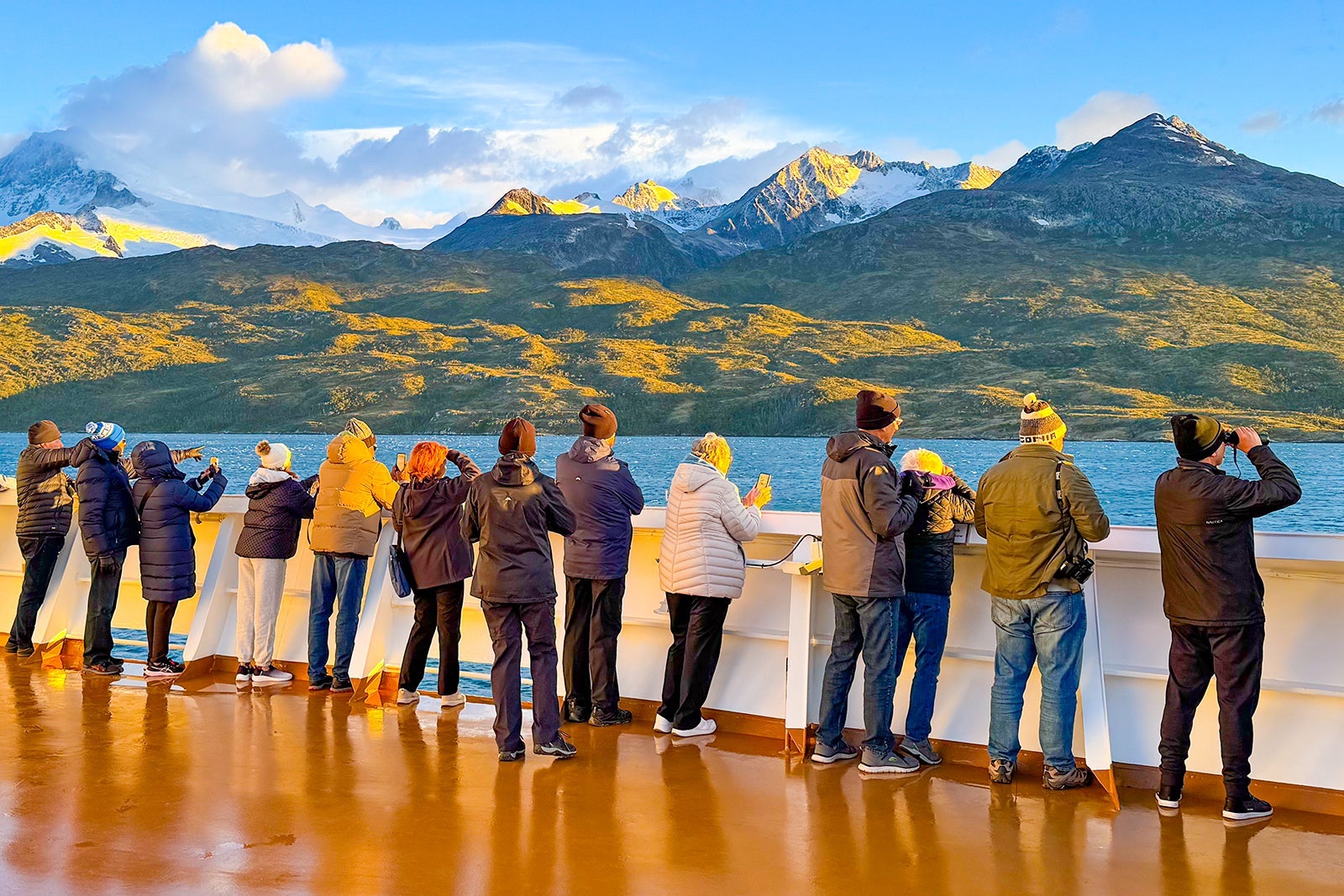 Passengers on Holland America cruise ship looking at glaciers in