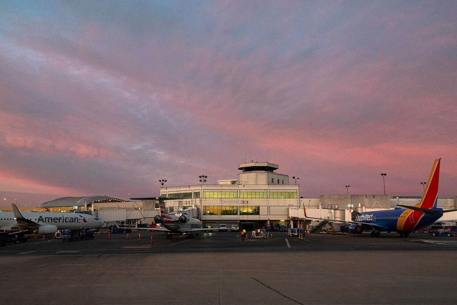 Airplanes are parked at jetways at Nashville International Airport at sunset