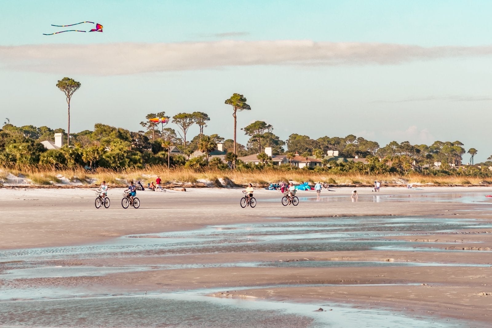 At low tide, the beach next to Palmetto Dunes presents a picturesque scene. Cyclists scene from a distance glide over the firm sand, and a few kites soar in the backdrop.