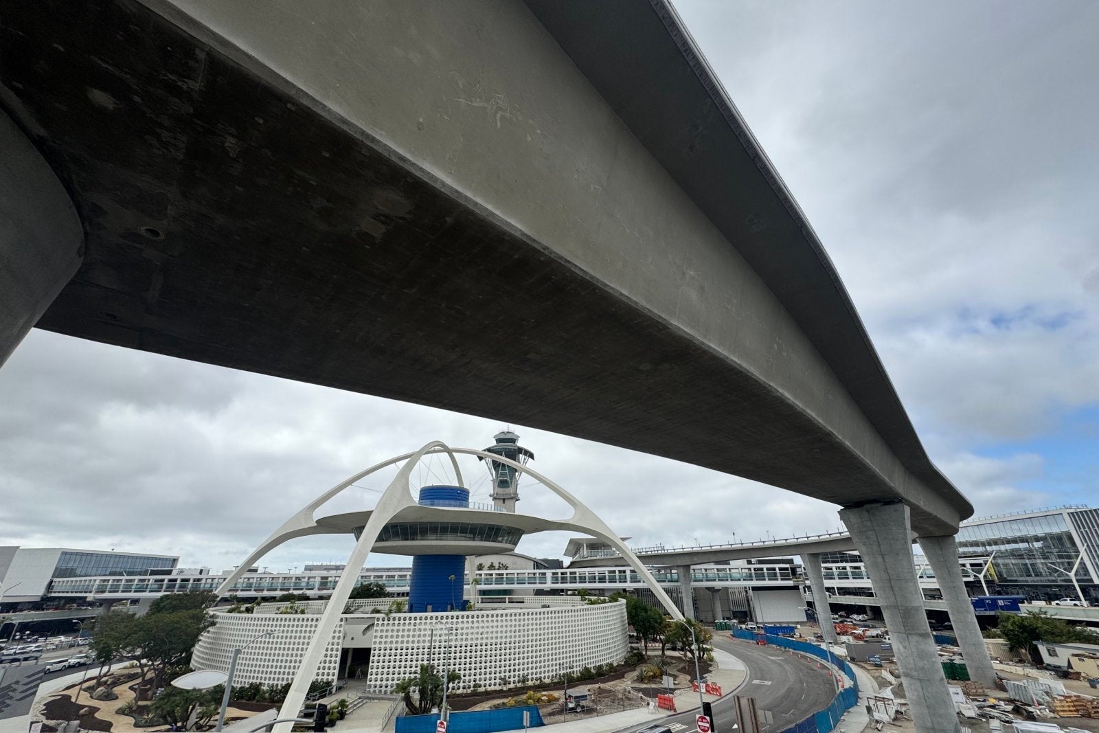 Construction is almost completed for the new automated People Mover train system. The track wraps around the LAX airport terminal. It is set to speed up passenger movement by expanding access with light rail and a new rental car facility just east of the main airport.
