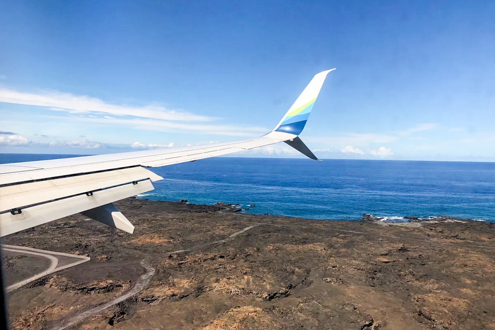 The approach into Kona International Airport (KOA) gives visitors a peek at the black lava of the Big Island.
