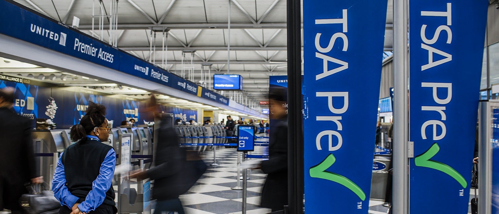 Passengers walk through the entrance of a TSA PreCheck in Terminal One at O'Hare International Airport.