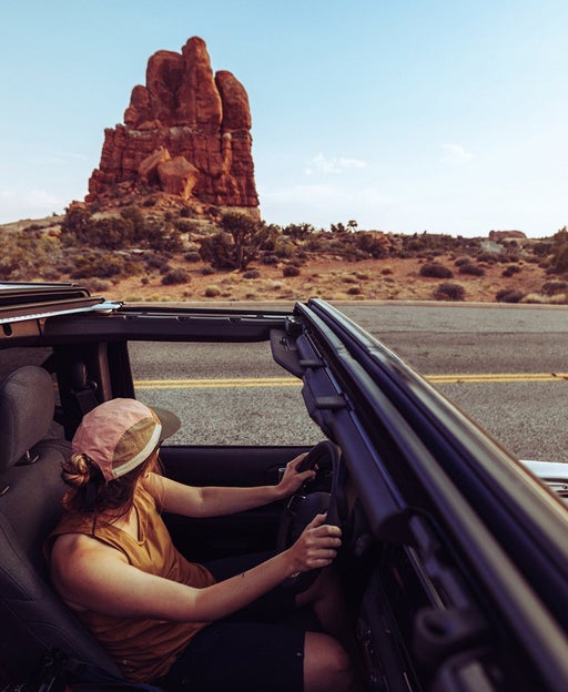 Woman driving offroad car in Arches National Park