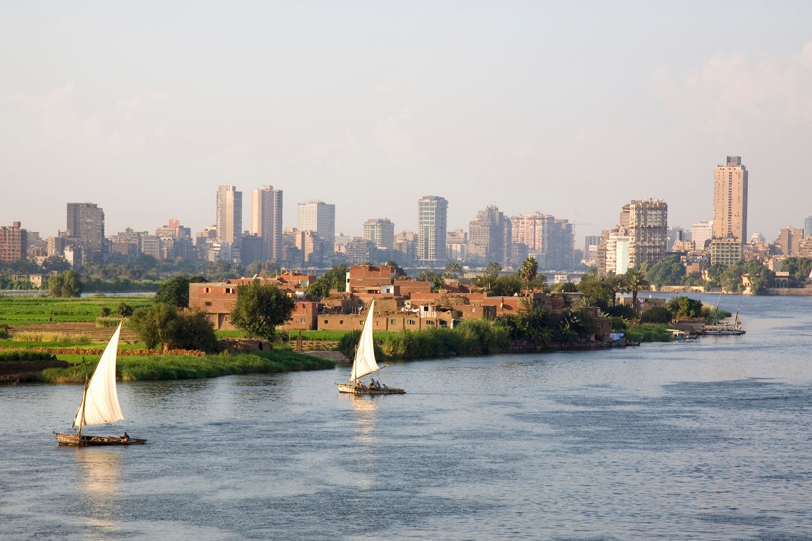 View of nile river from cairo bridgeway with two felukas sailing
