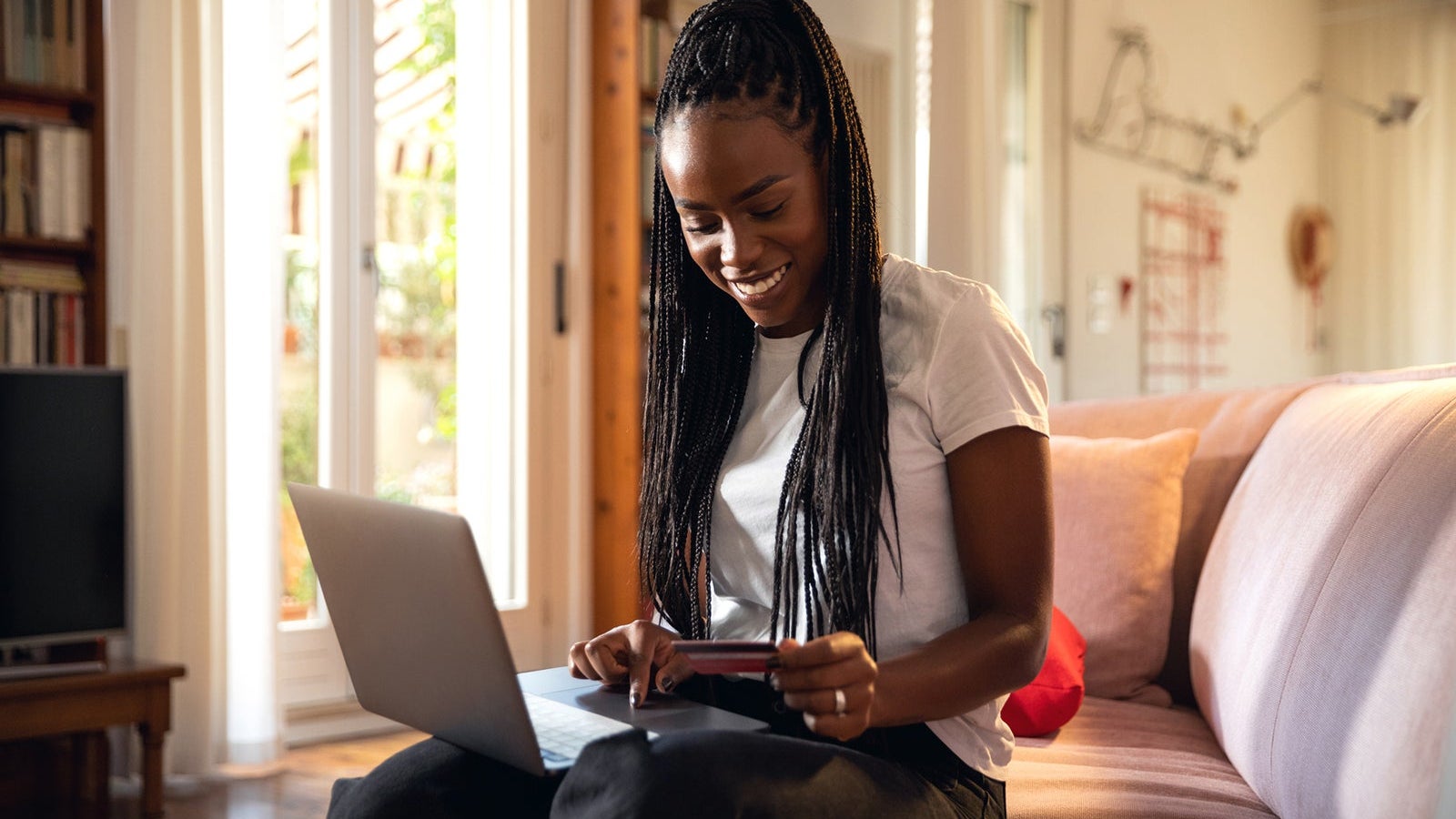 Woman shopping online and relaxing on the sofa at home