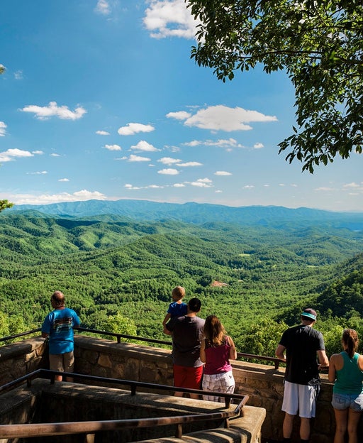 A family group stops at the Look Rock area of Foothills Parkway West in Great Smoky Mountains National Park to enjoy the summer view of the Appalachian Mountains. This image is looking north-east into the park.