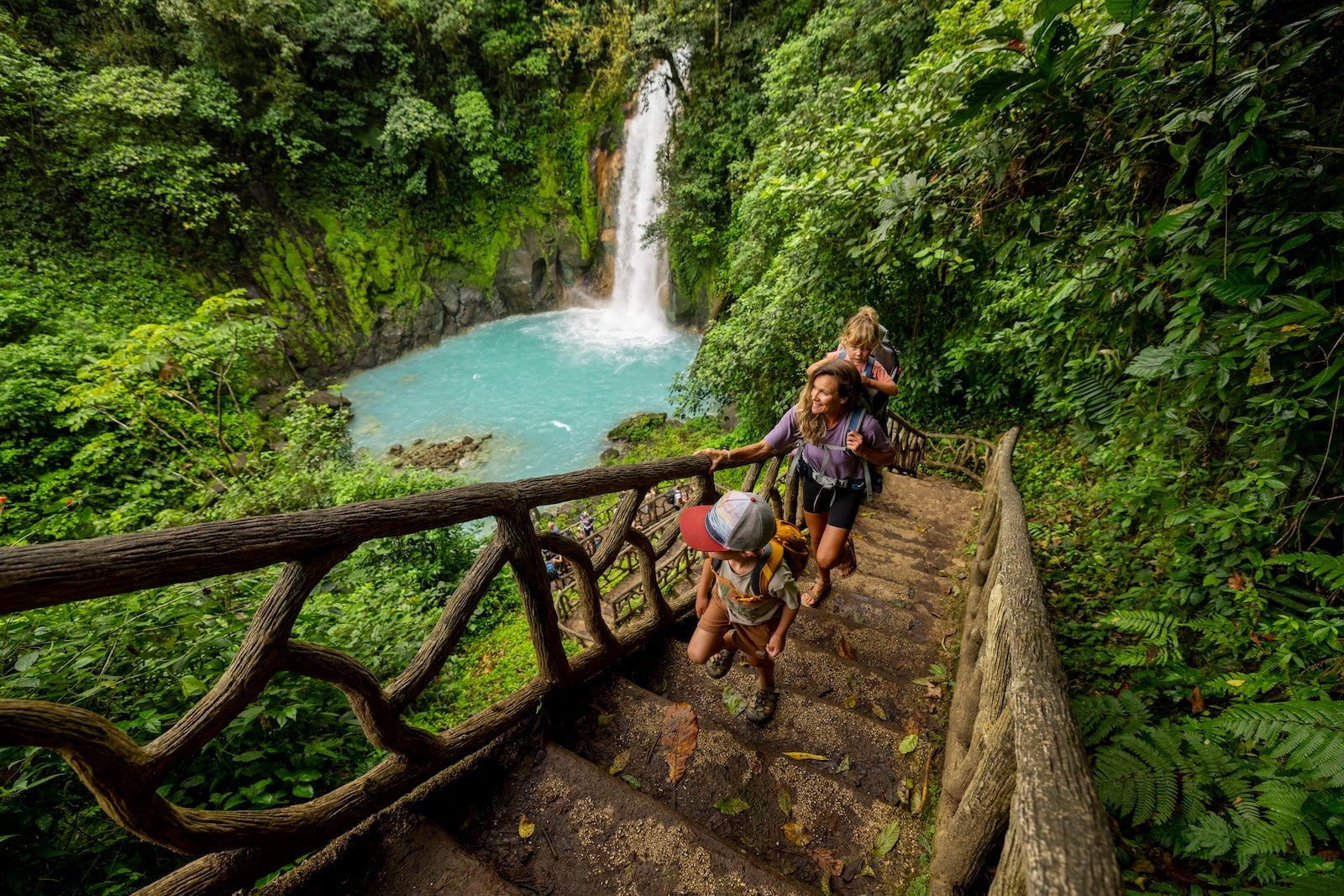A family hiking at Rio Celeste waterfall in Costa Rica.