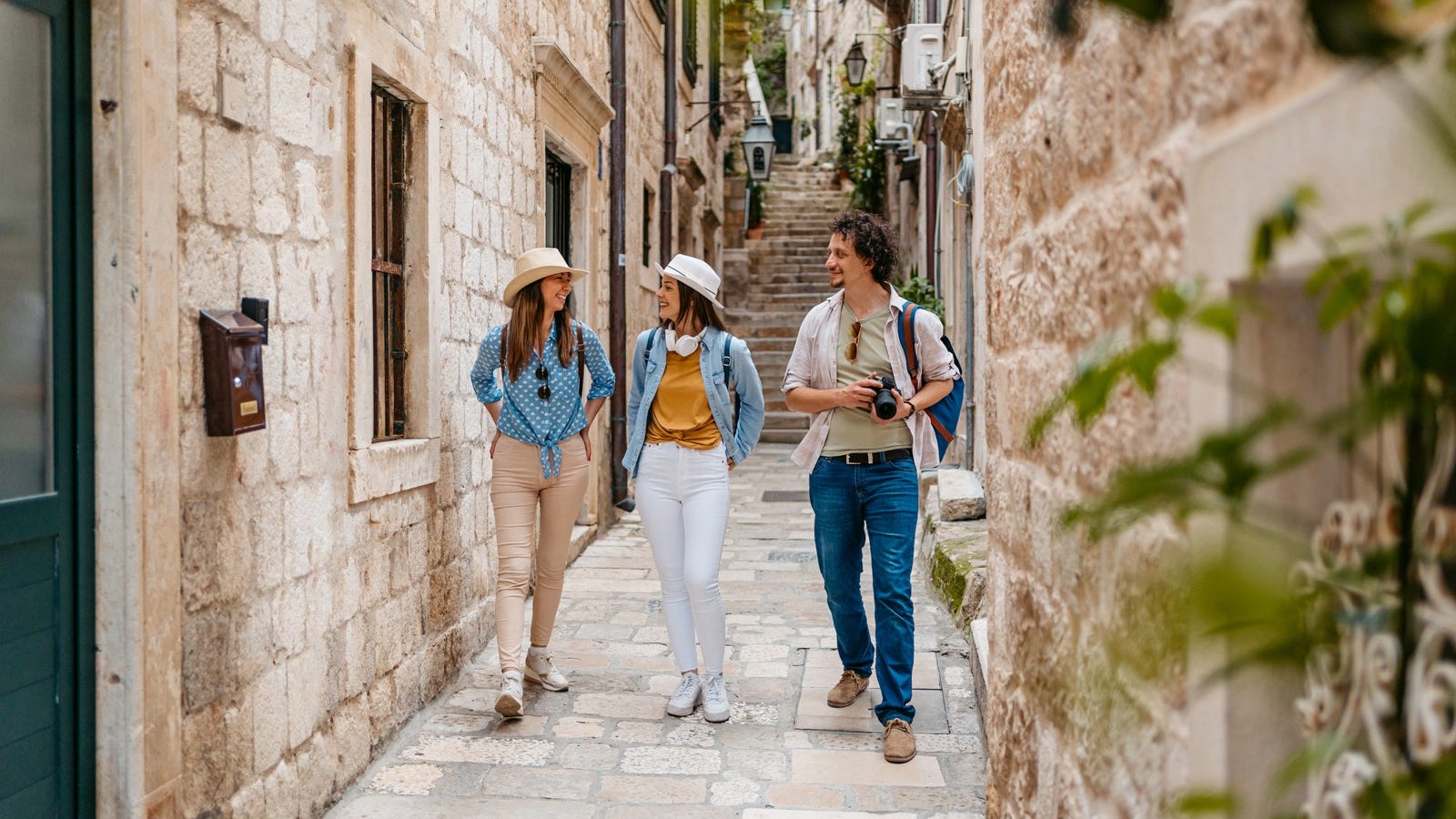 Three Young Friends Walking In An Alley In Dubrovnik