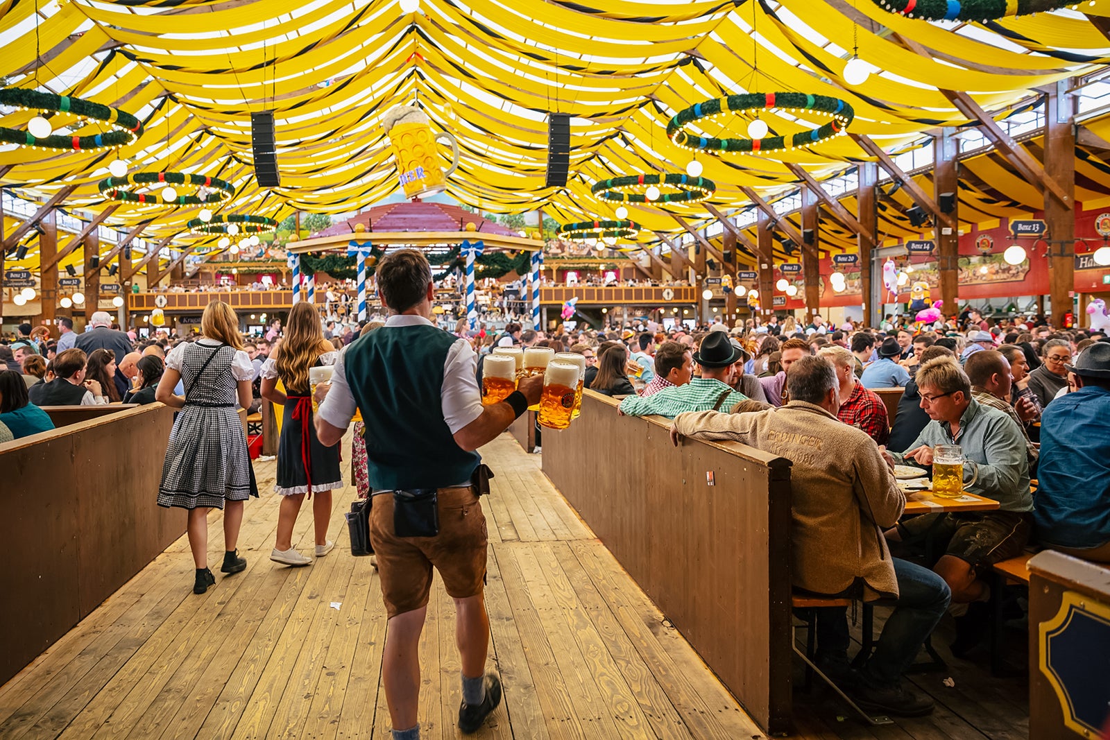 Best places to travel in September 2025 Water holding beers at Oktoberfest in Munich, Germany
