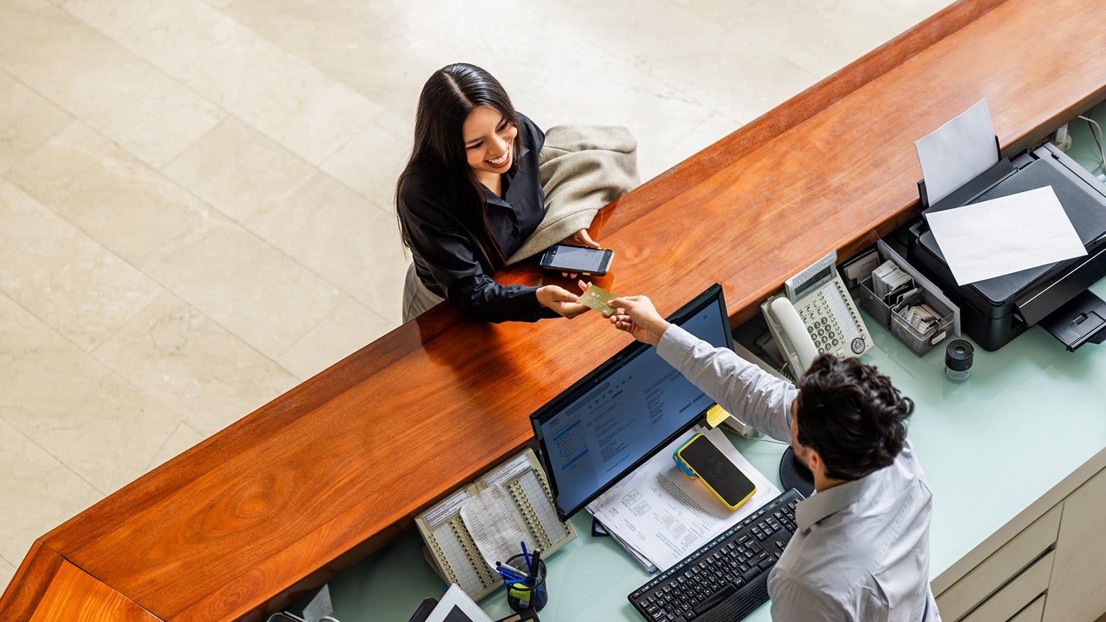 Woman traveling for business and paying by card at the hotel