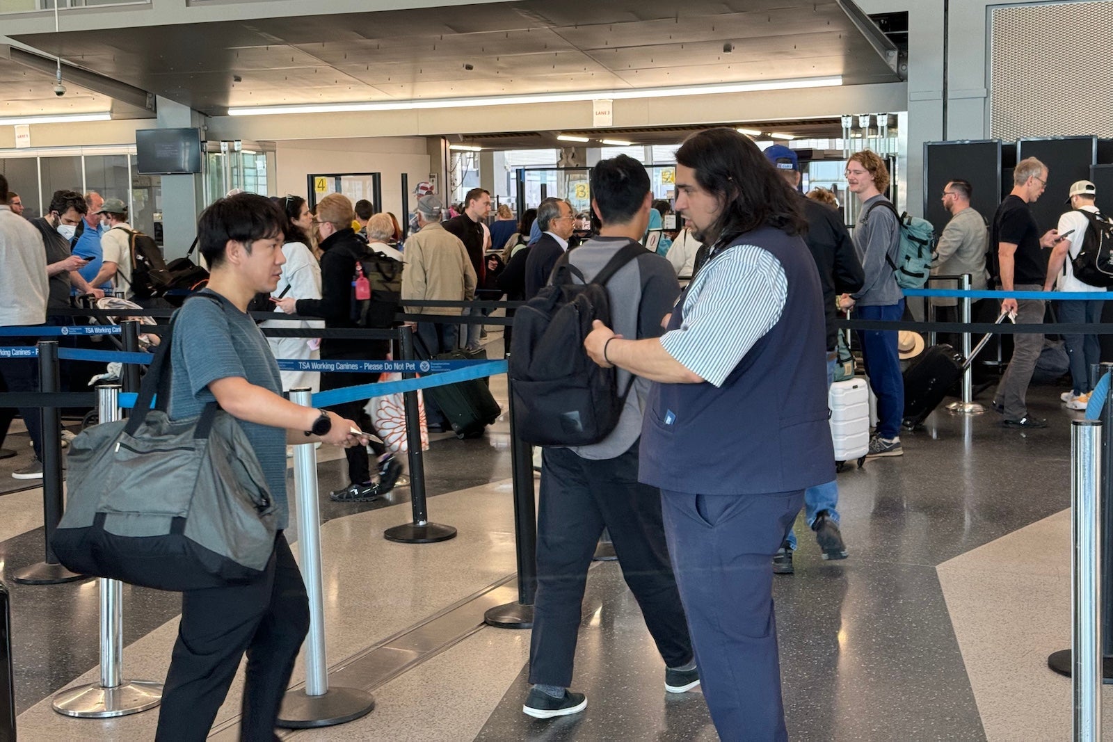 An American Airlines representative screens passengers for Real ID at Chicago's O'Hare International Airport (ORD). SEAN CUDAHY/THE POINTS GUY