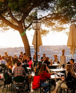 Cafe overlooking Lisbon, Portugal with bridge visible in the distance.