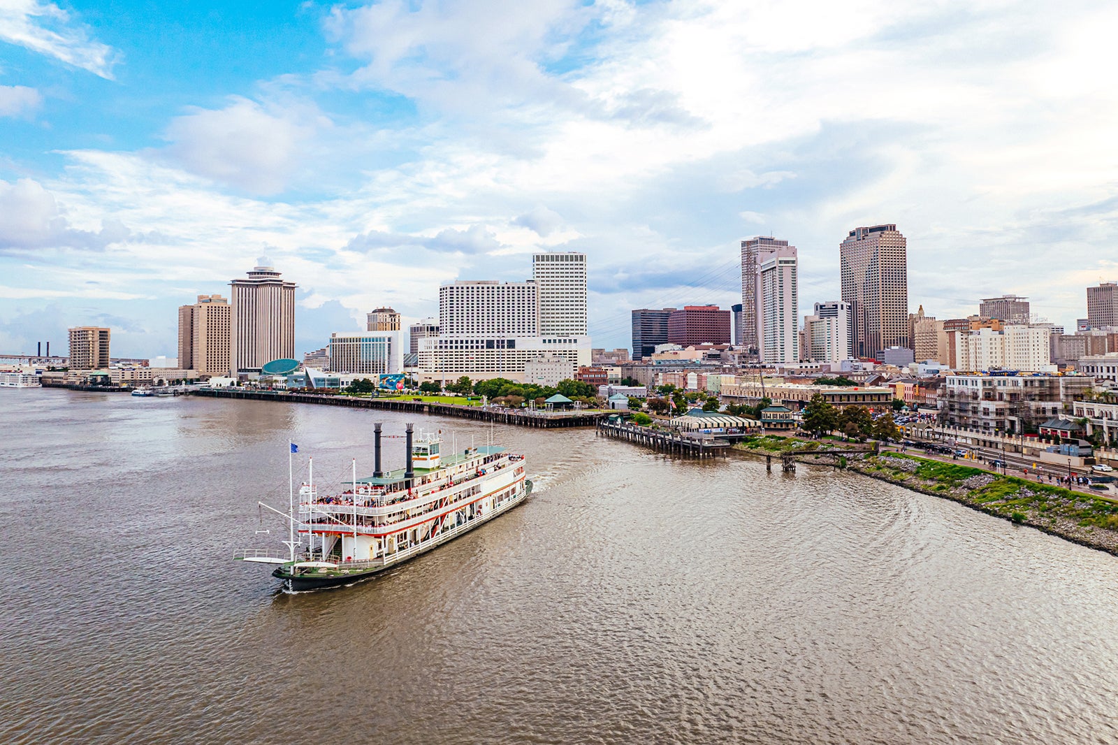 New Orleans Louisiana Skyline with Tourboat departing on the Mississippi River along the Riverwalk and Jackson Square