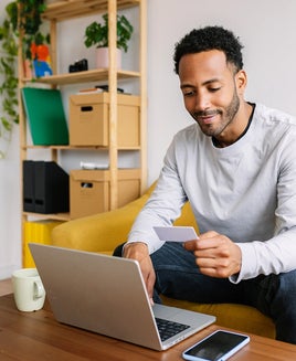 Man making an online purchase at home