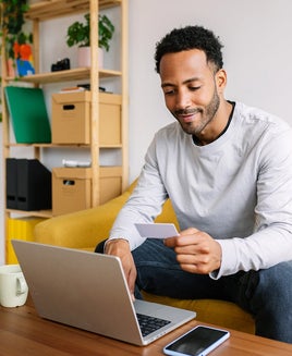 Man making an online purchase at home