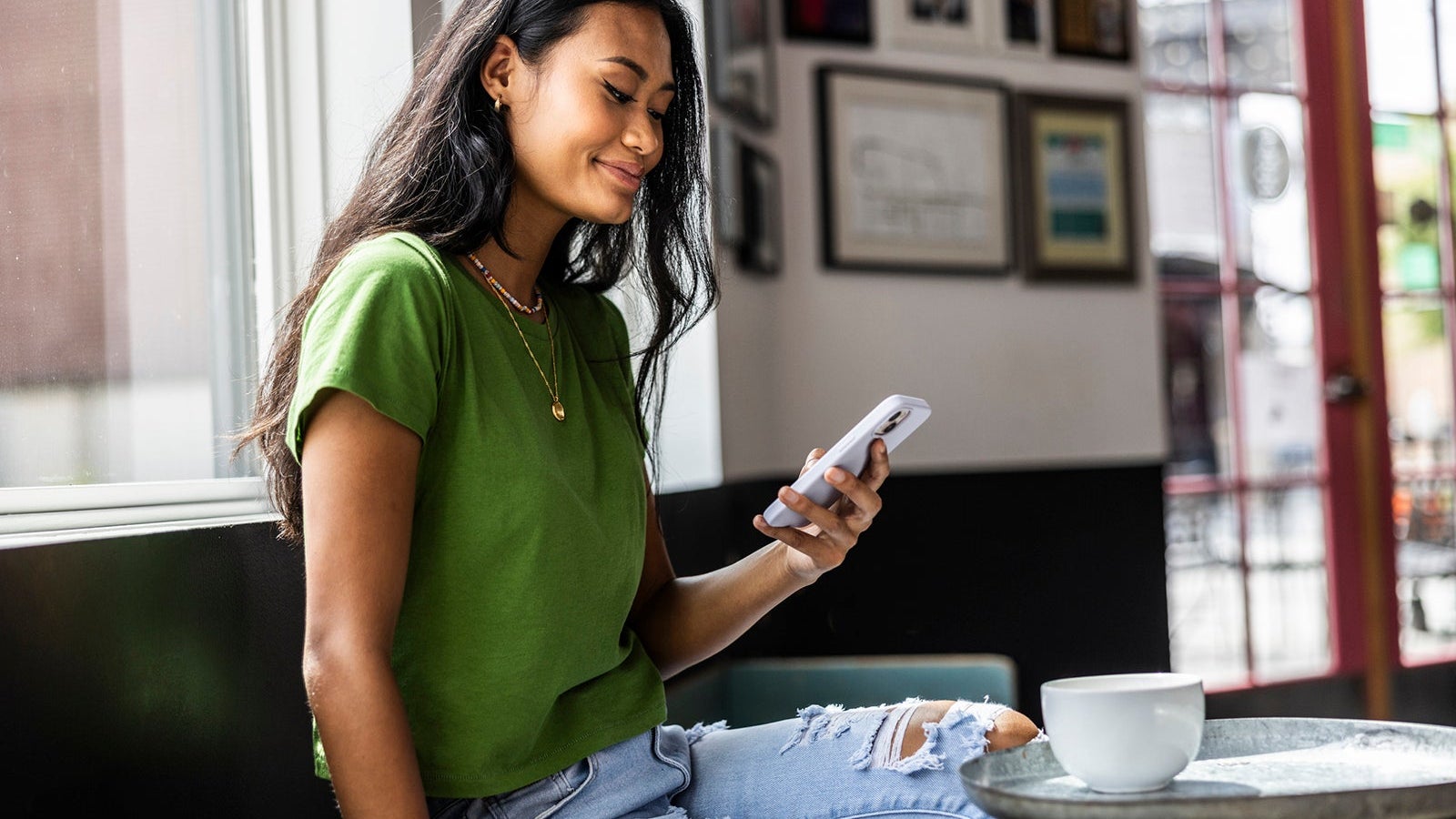 Young woman using smartphone in coffeeshop