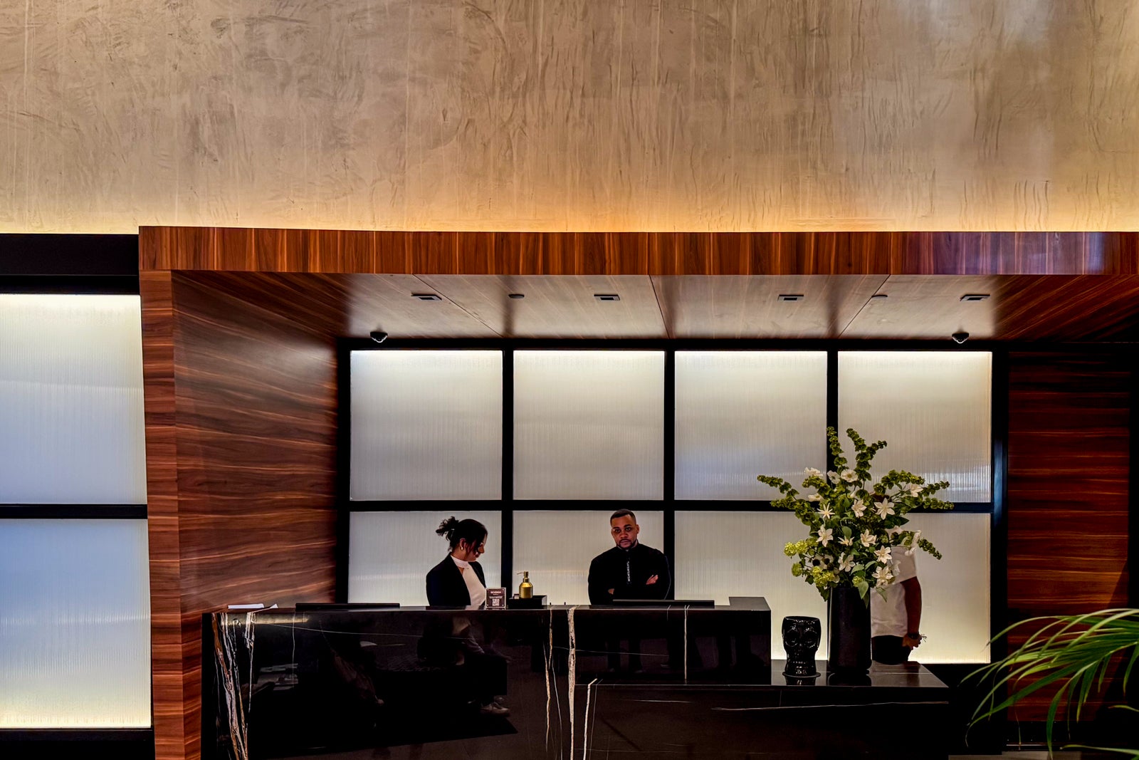 Gansevoort Meatpacking NYC review: Luxe hotel with a rooftop pool and more two people standing at hotel desk
