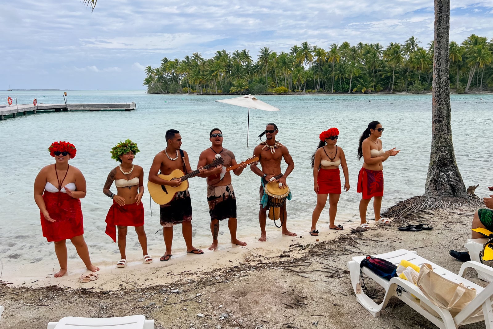 The Gauguins and Gauguines entertain passengers at Motu Mahana with traditional songs.