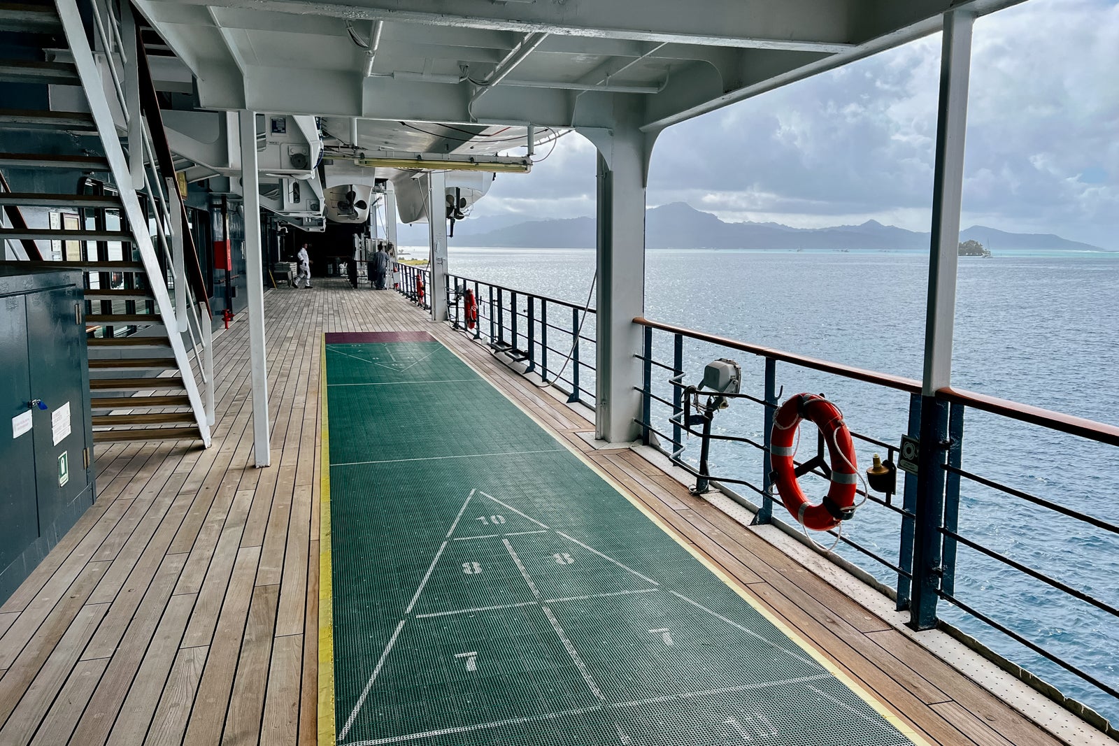 A promenade deck on Paul Gauguin features shuffleboard courts.