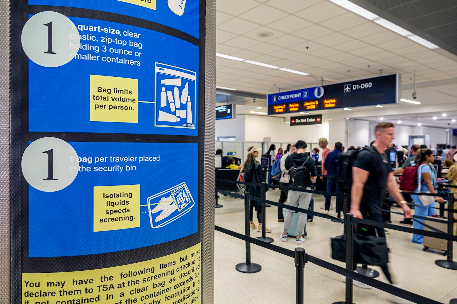 Signs explain the TSA's liquids policy at Miami International Airport