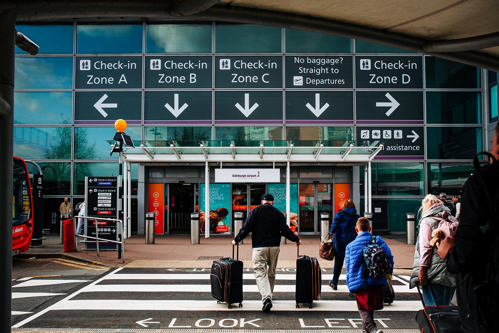 Travelers enter Edinburgh Airport in Edinburgh, UK,