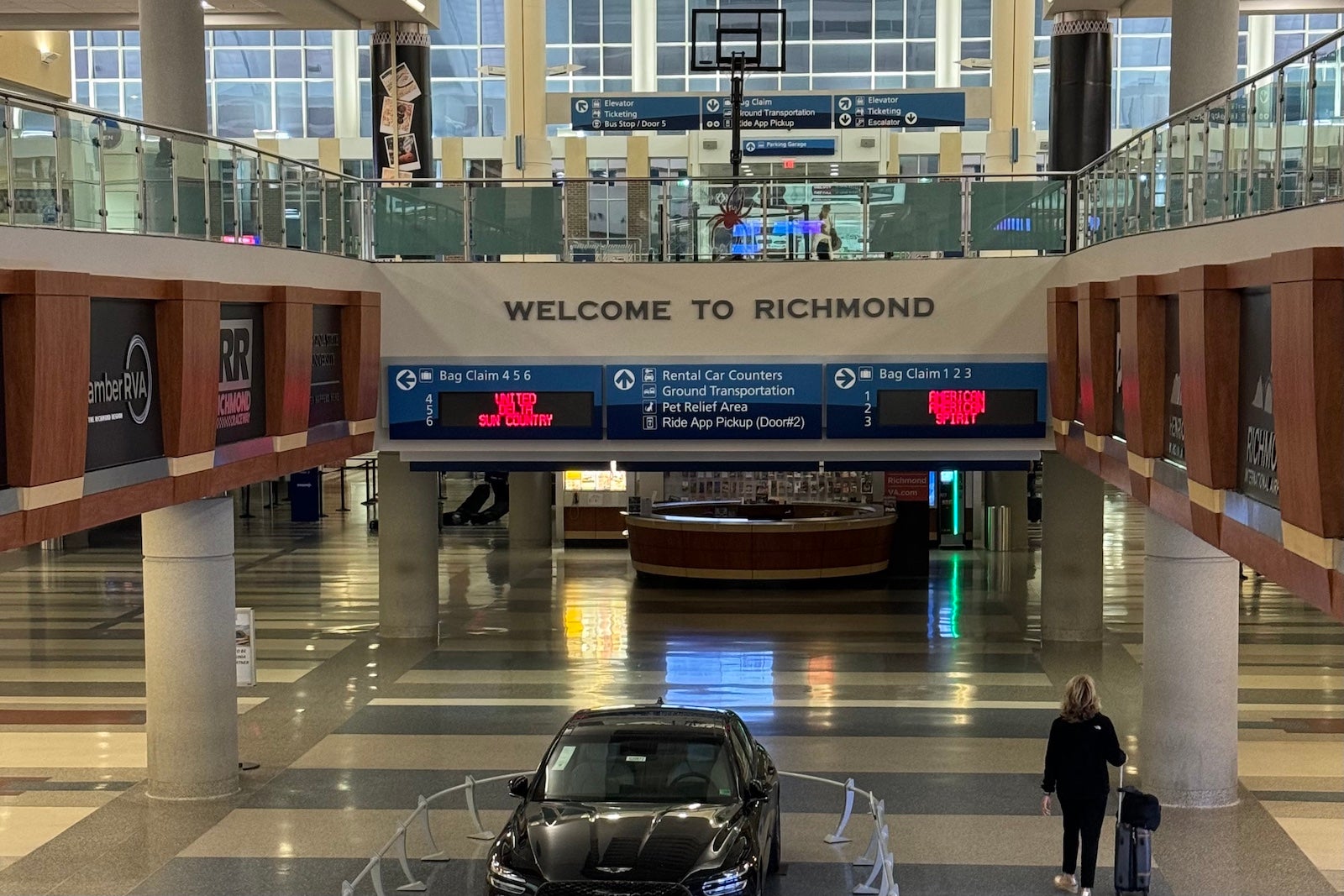 a traveler walks through a mostly empty airport terminal