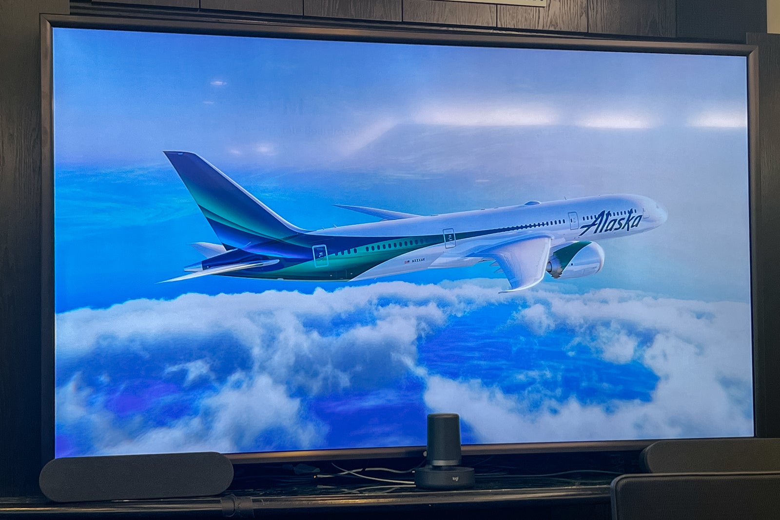A screen shows an image of a Alaska Airlines aircraft