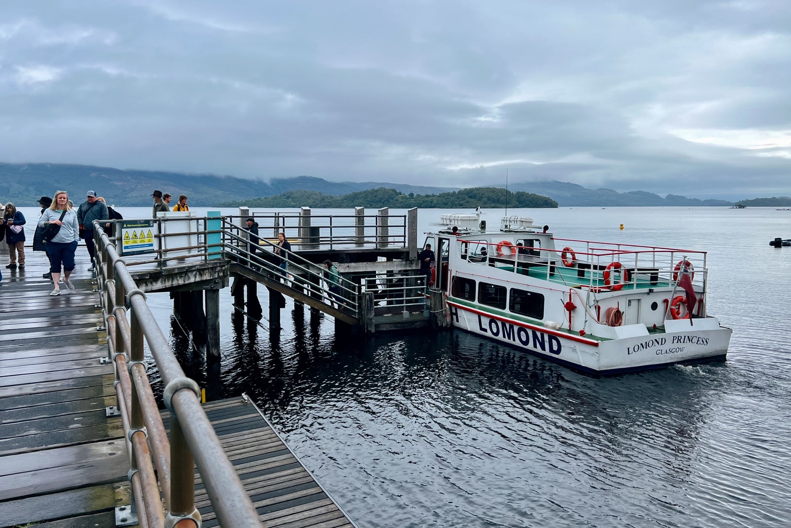Globus tourgoers board a boat for a tour of Scotland's Loch Lomond.