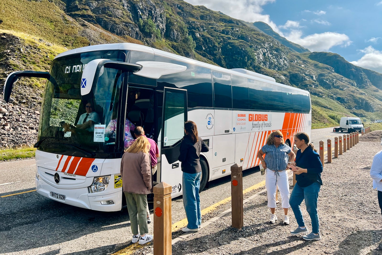 Tourgoers board a Globus bus