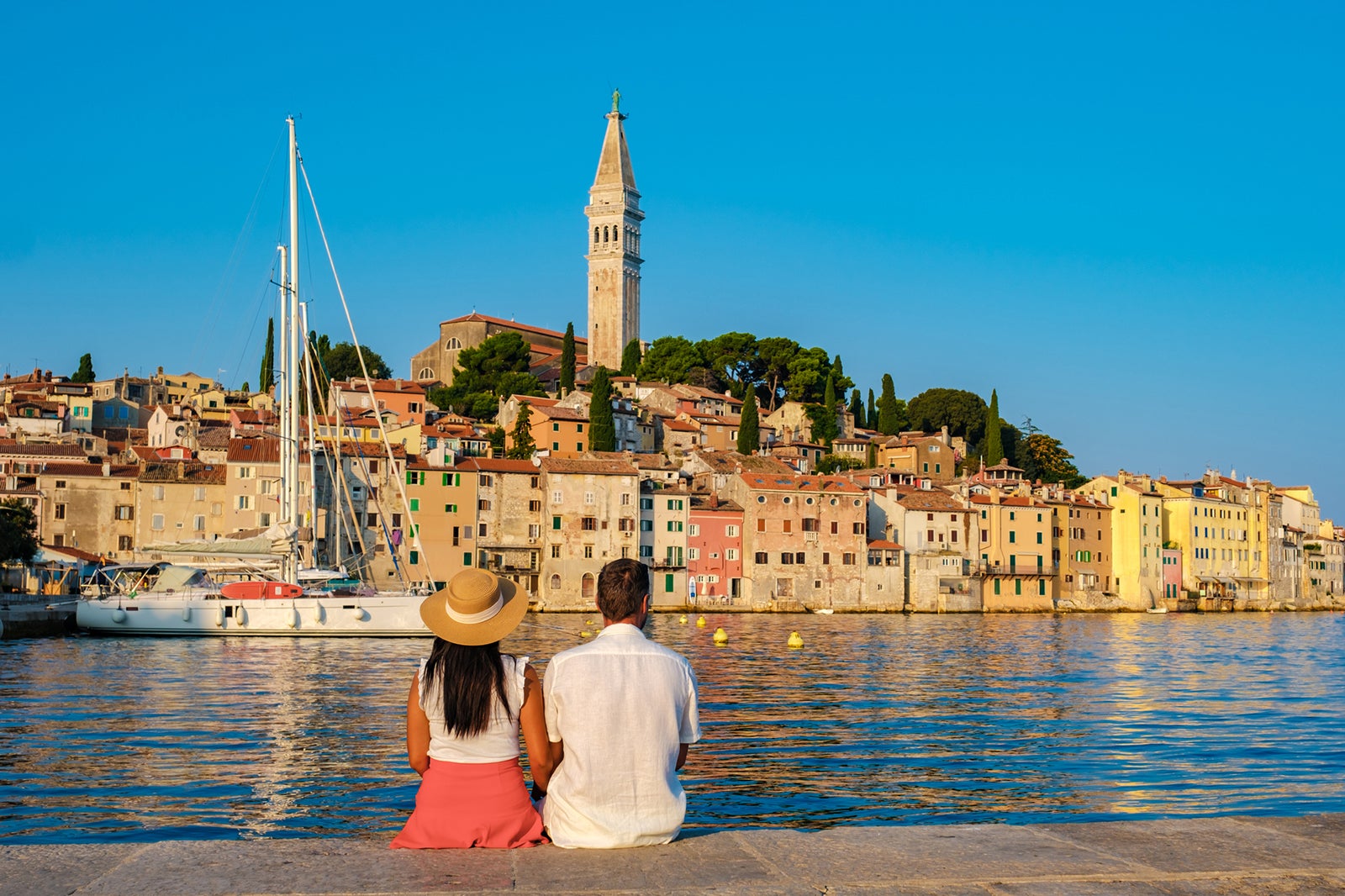 Looking to cancel the Chase Sapphire Reserve? Consider this Couple sitting together seaside in Croatia