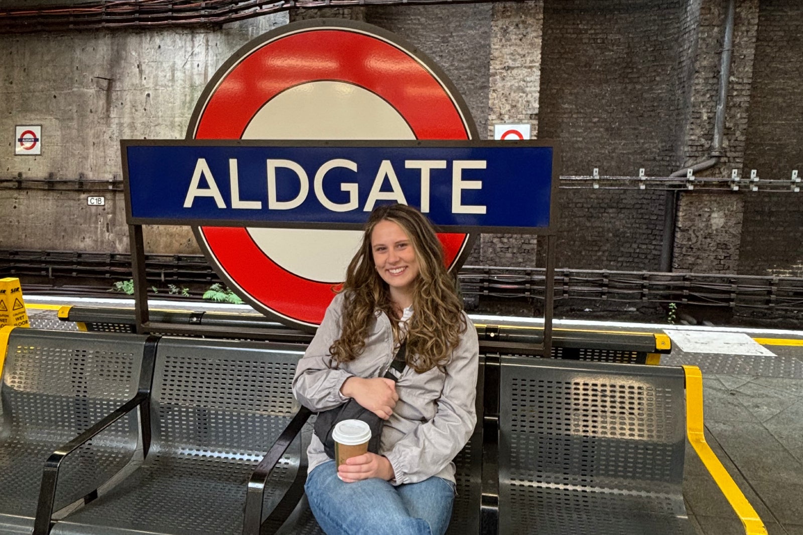 Woman sitting outside of London tube station