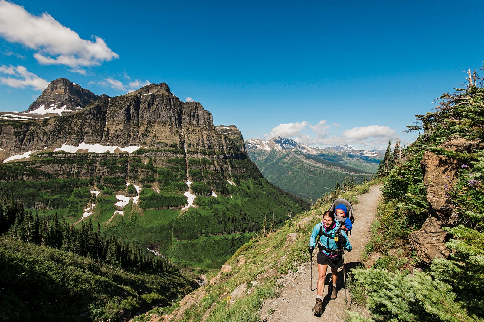 Women and child hiking on the Highline Trail in Glacier National Park, Montana.