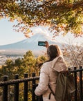 Woman tourist with mount Fuji at Chureito Pagoda in Autumn season, Traveler travel Arakurayama Sengen Park, Yamanashi, Japan. Landmark for tourist attraction. Japan Travel, Destination and Vacation