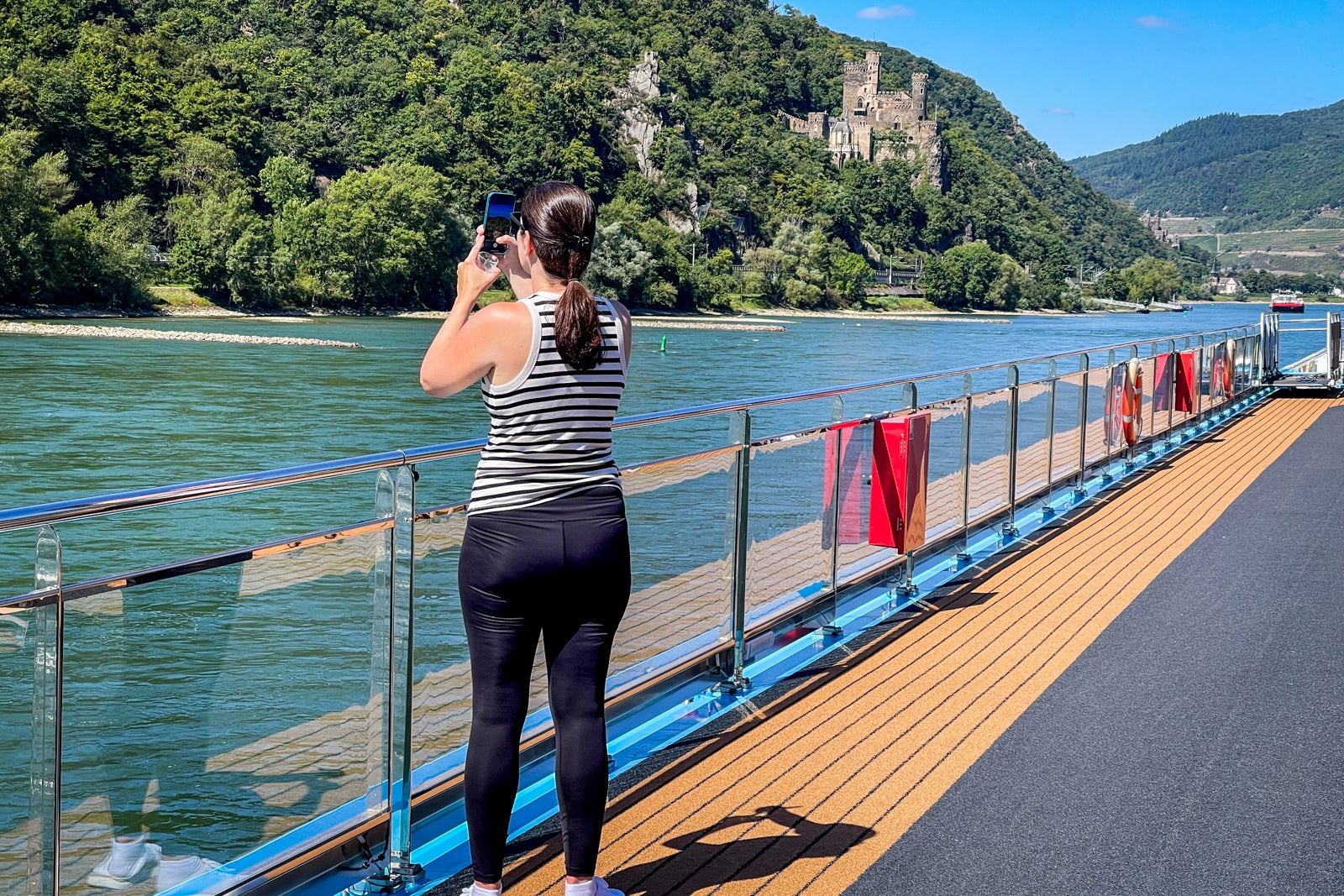 AmaWaterways' passenger enjoying the Rhine River Gorge and its castles on a summertime cruise.