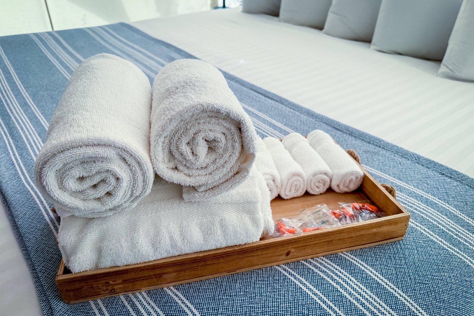 towels and earplugs on a tray