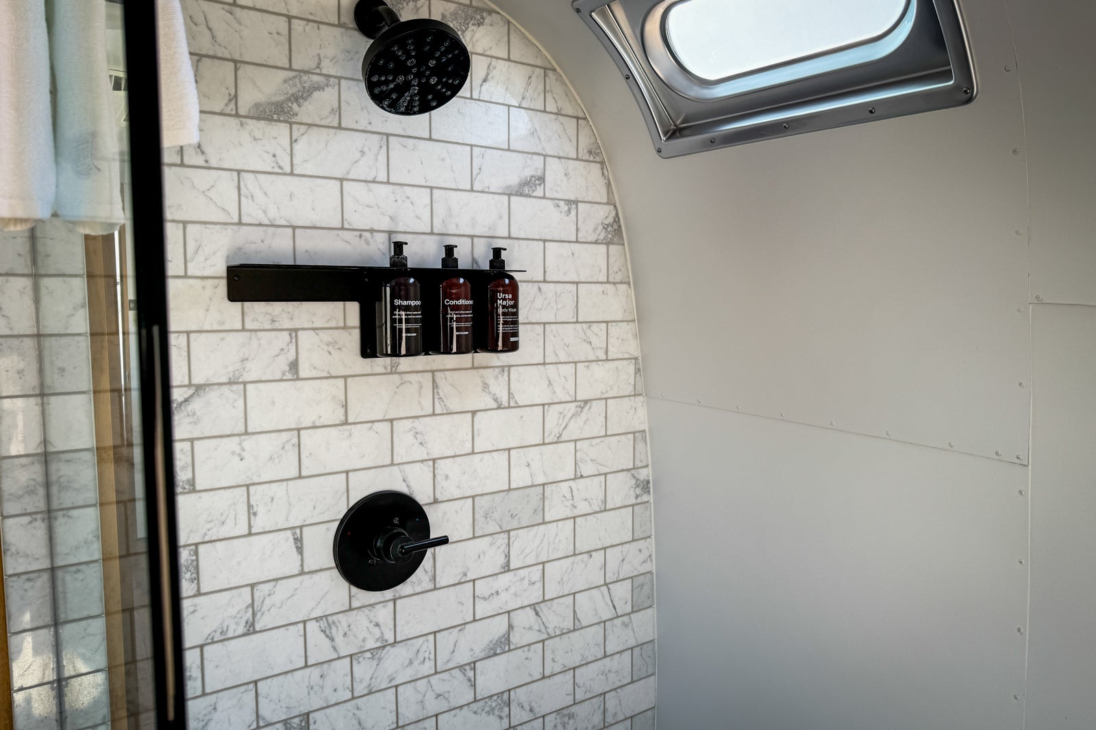 bathroom shower with white tile
