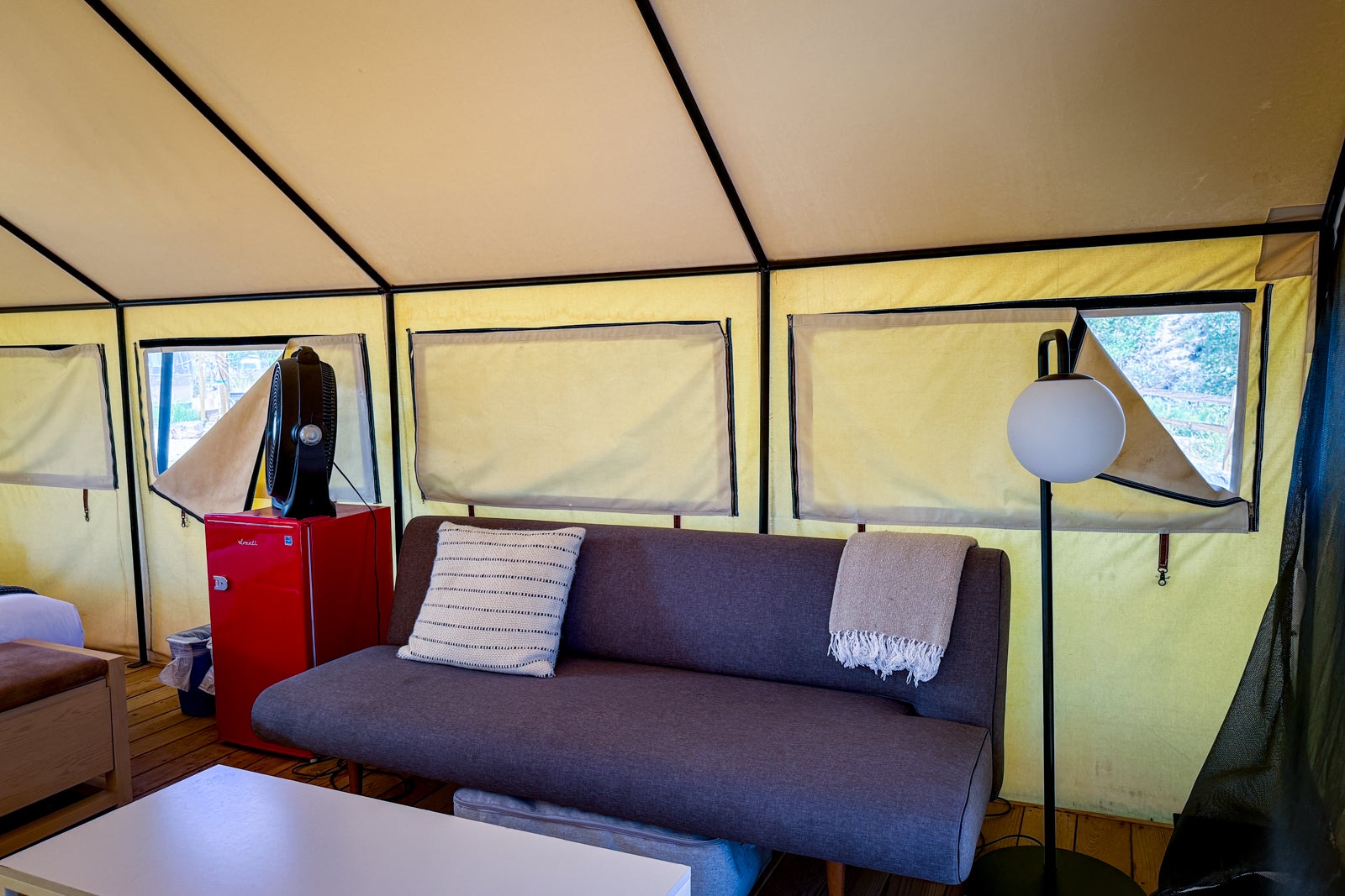 couch and lamp inside a tent