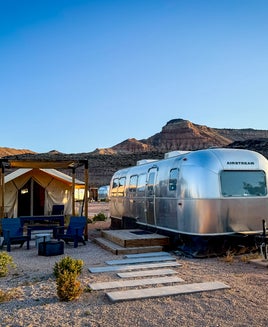 airstream with a tent next to it