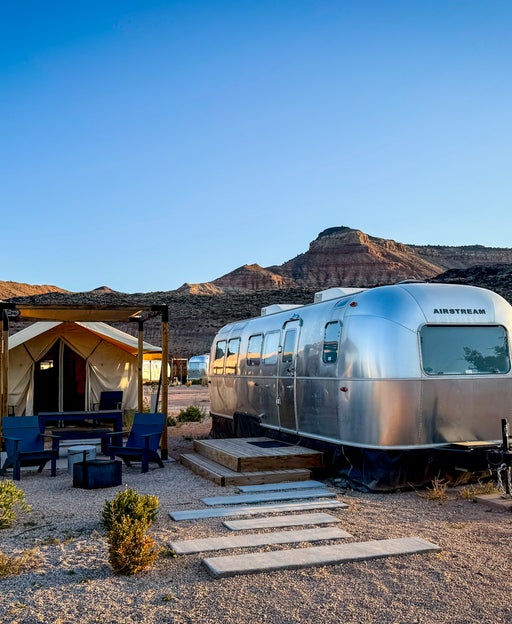 airstream with a tent next to it