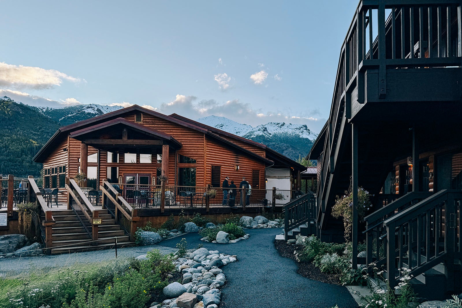 log building with mountains behind