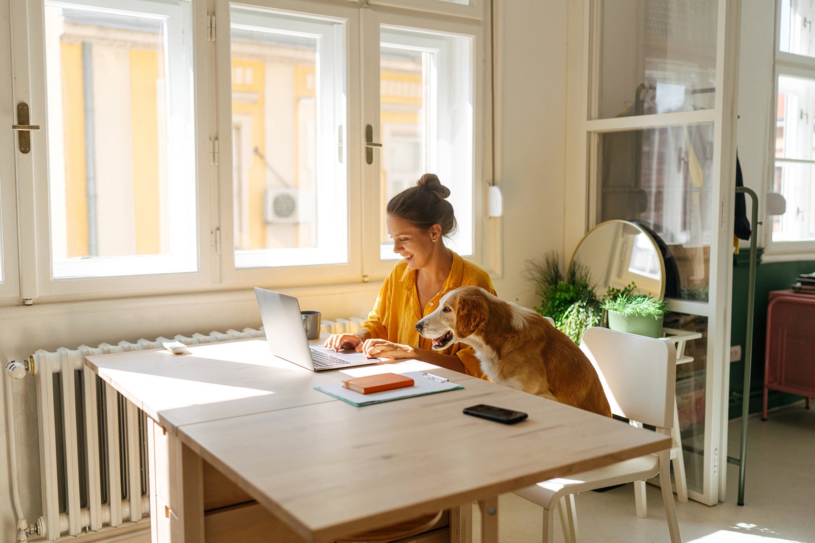Woman using a laptop in her kitchen