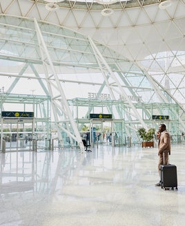 businessman talking on phone in airport terminal after arriving on flight