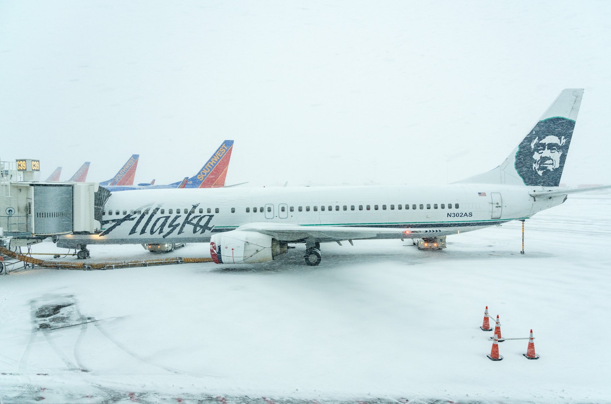 Alaskan Airways and Southwest planes lined up in snow storm