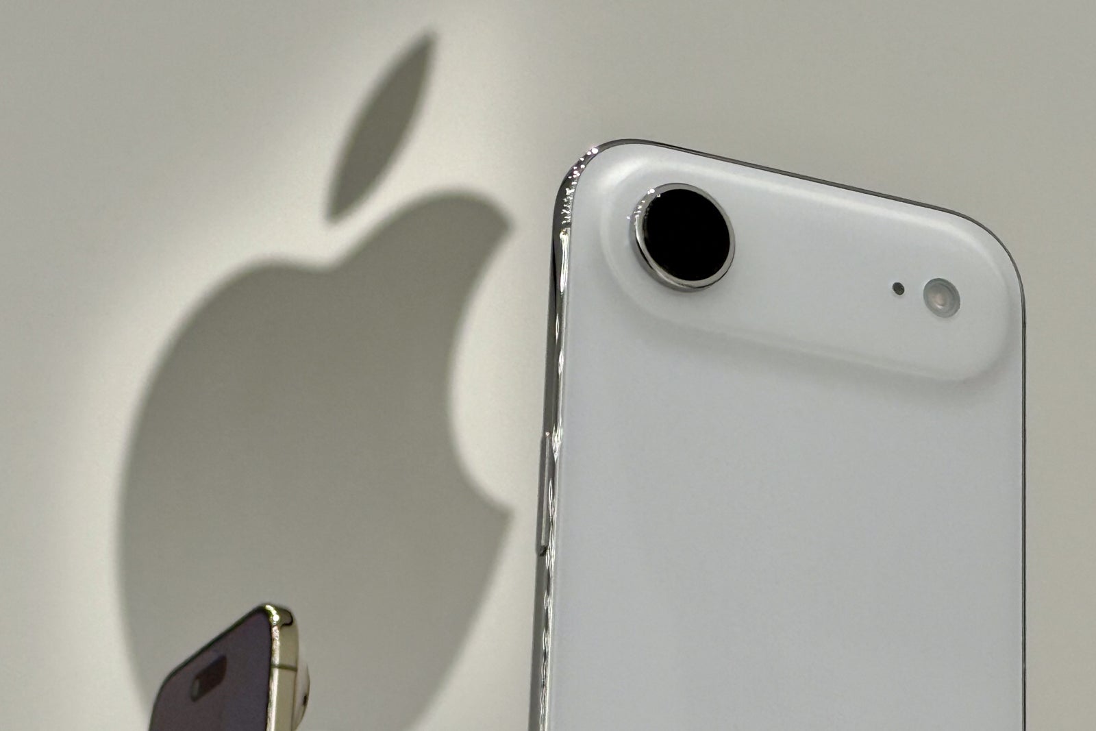 a view of a white iPhone at a press event