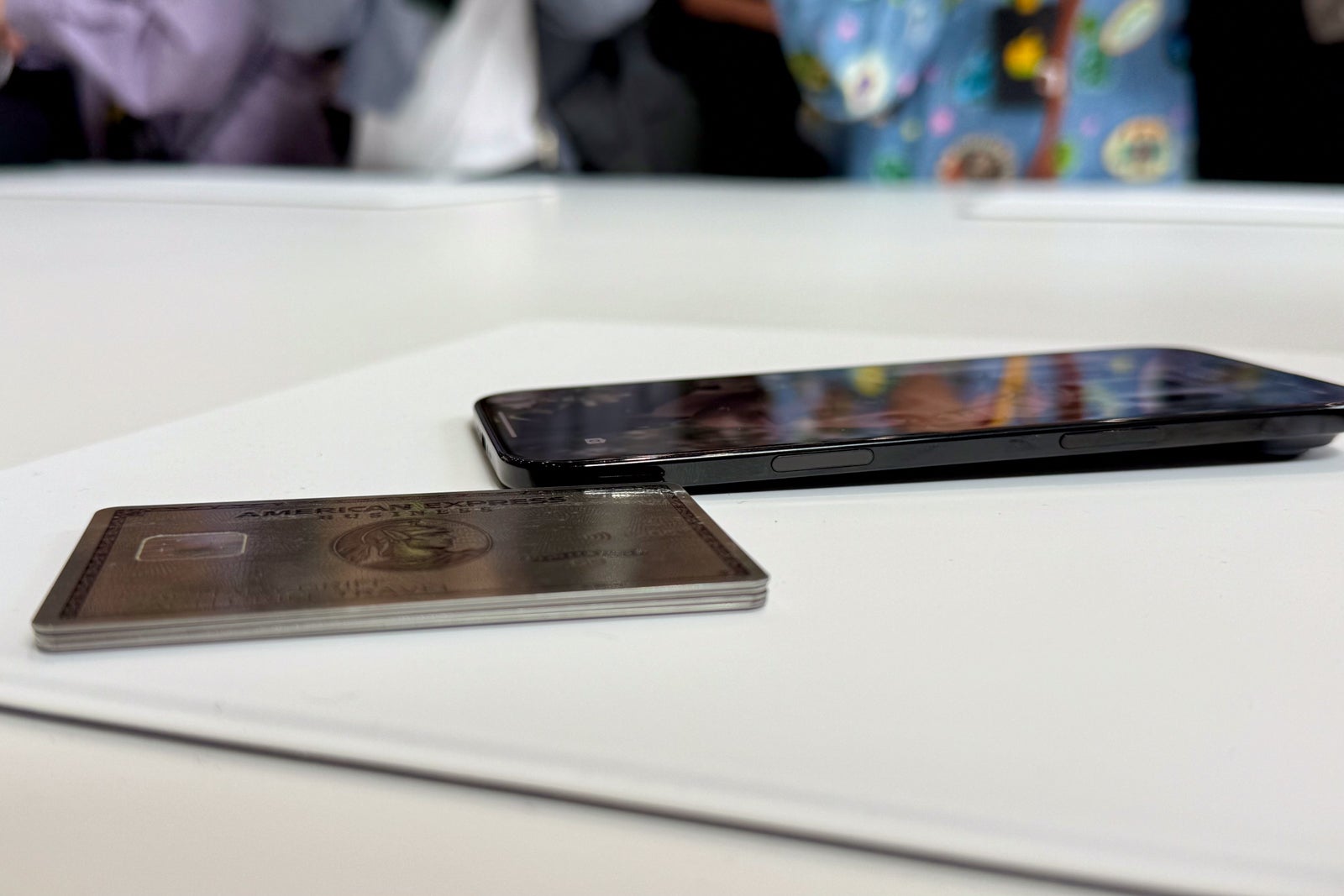 a stack of credit cards next to an iPhone Air